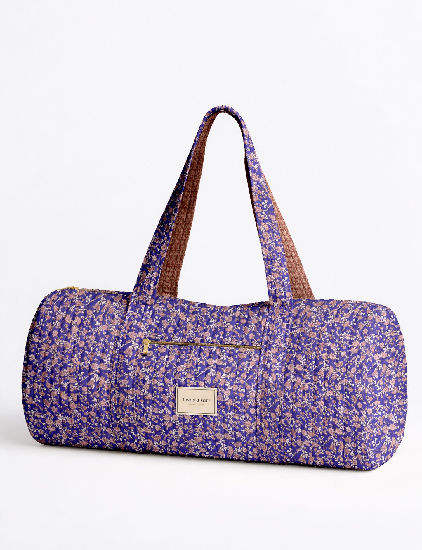 Brown paisley quilted bowling bag with dual handles, front zipper pocket, and "I was a sari" label on front side