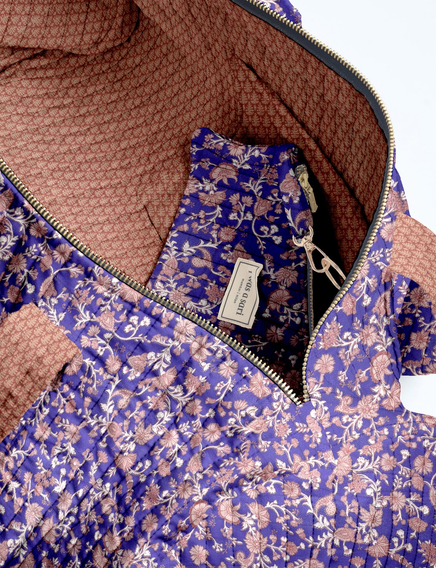 Brown paisley quilted bowling bag with dual handles, front zipper pocket, and "I was a sari" label on front side