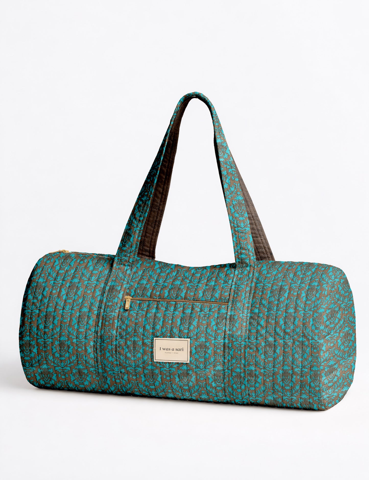 Brown paisley quilted bowling bag with dual handles, front zipper pocket, and "I was a sari" label on front side