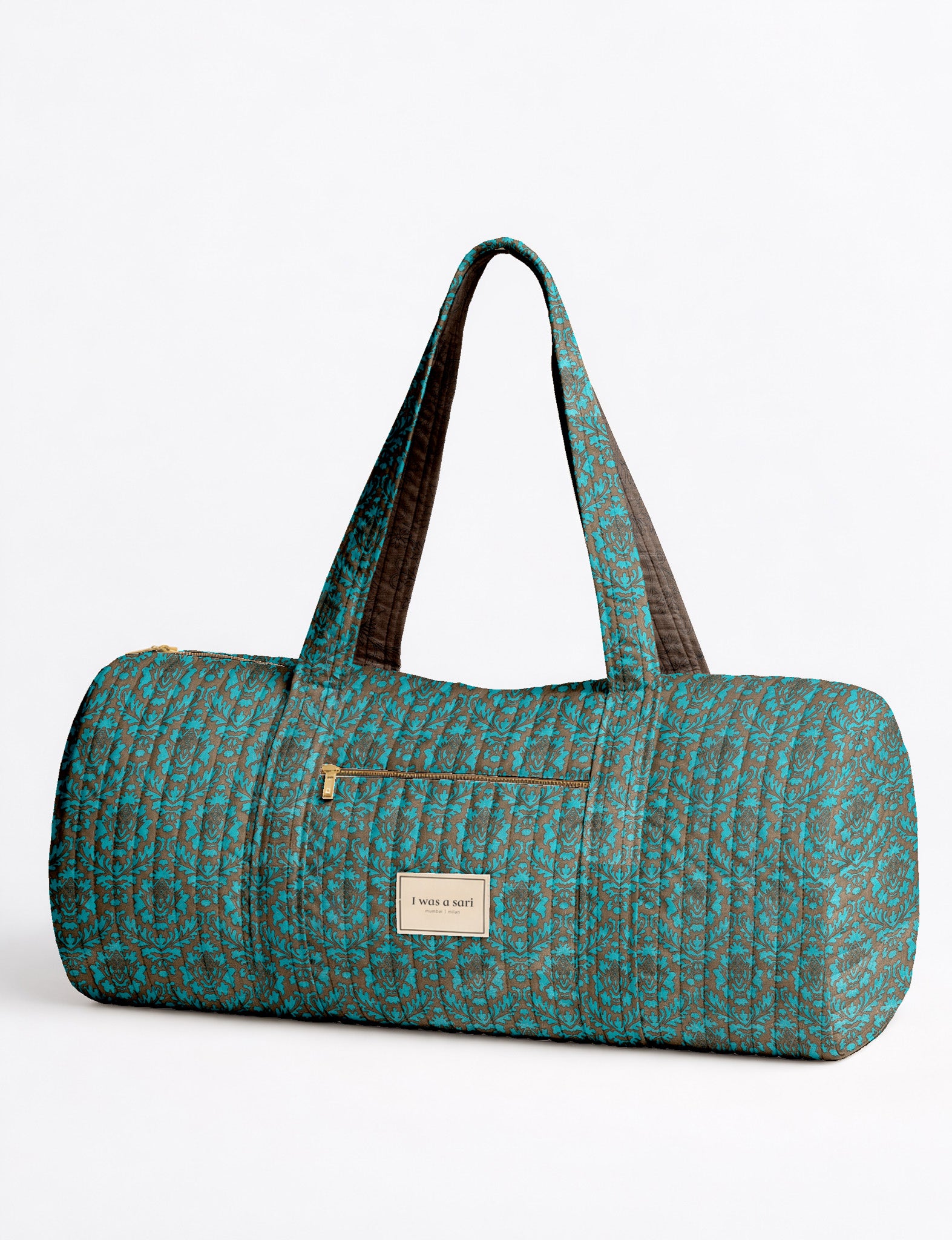 Brown paisley quilted bowling bag with dual handles, front zipper pocket, and "I was a sari" label on front side