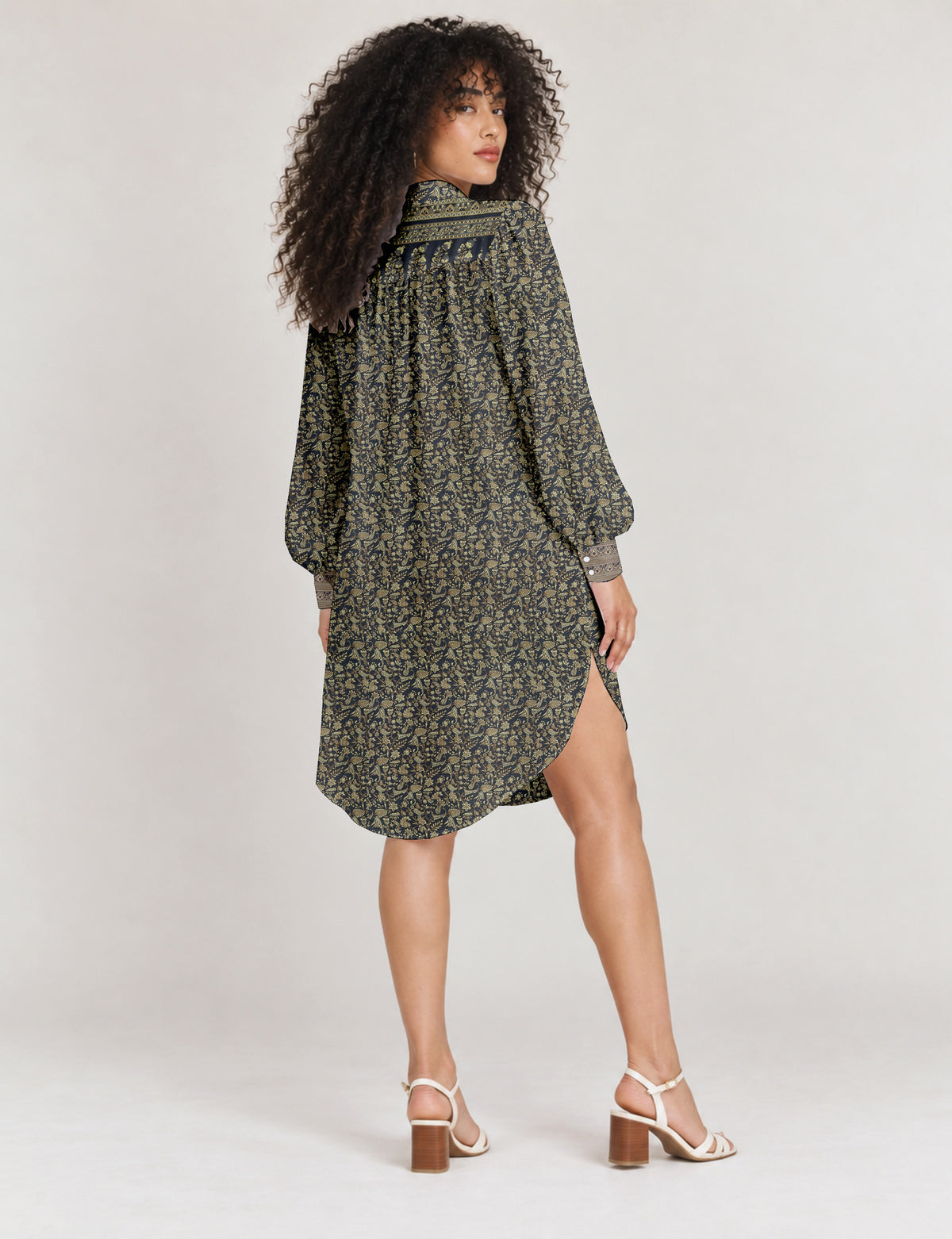 High low shirt with a relaxed fit, button-down front, classic collar, gathered shoulders and full-length blouson sleeves.