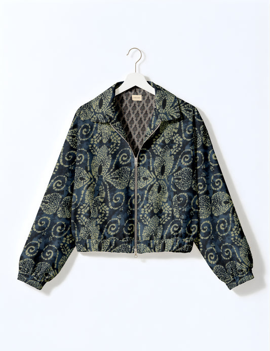 Women's cropped bomber jacket with twin metallic front zippers, welt pockets, elasticated hem and cuffs, and contrast sari print lining.