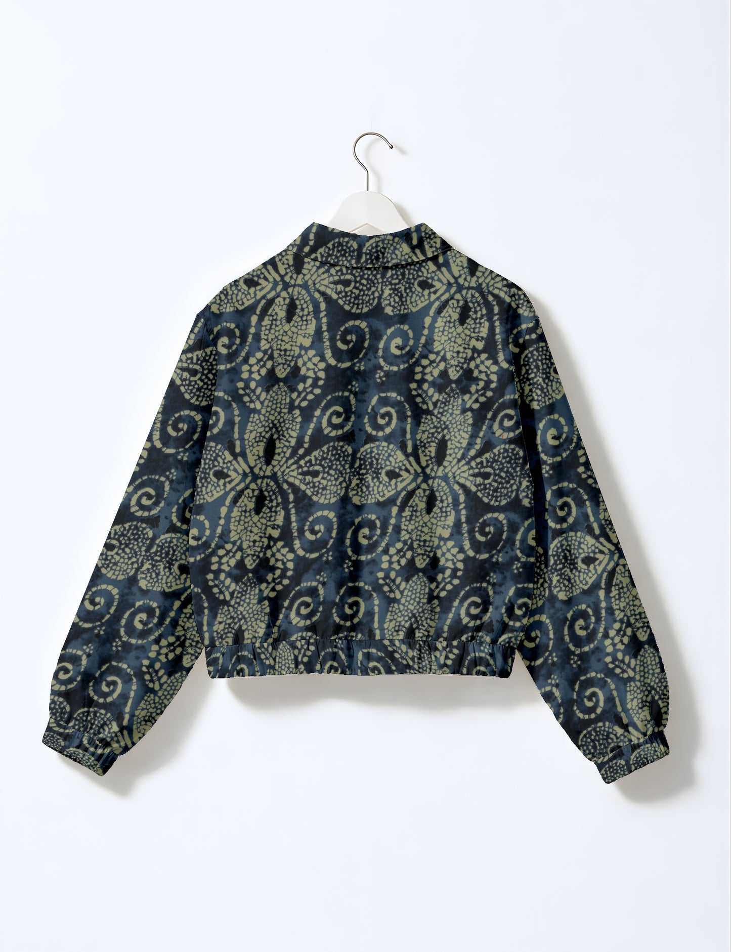 Women's cropped bomber jacket with twin metallic front zippers, welt pockets, elasticated hem and cuffs, and contrast sari print lining.