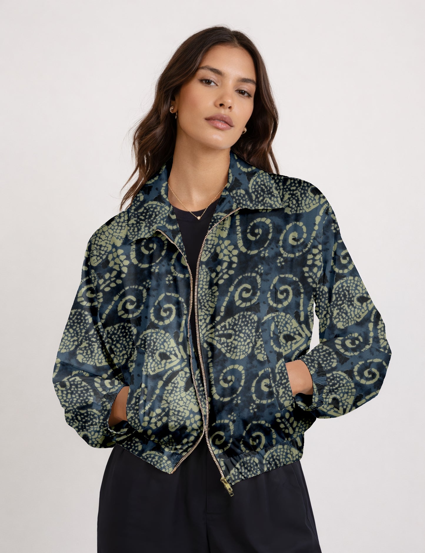 Women's cropped bomber jacket with twin metallic front zippers, welt pockets, elasticated hem and cuffs, and contrast sari print lining.