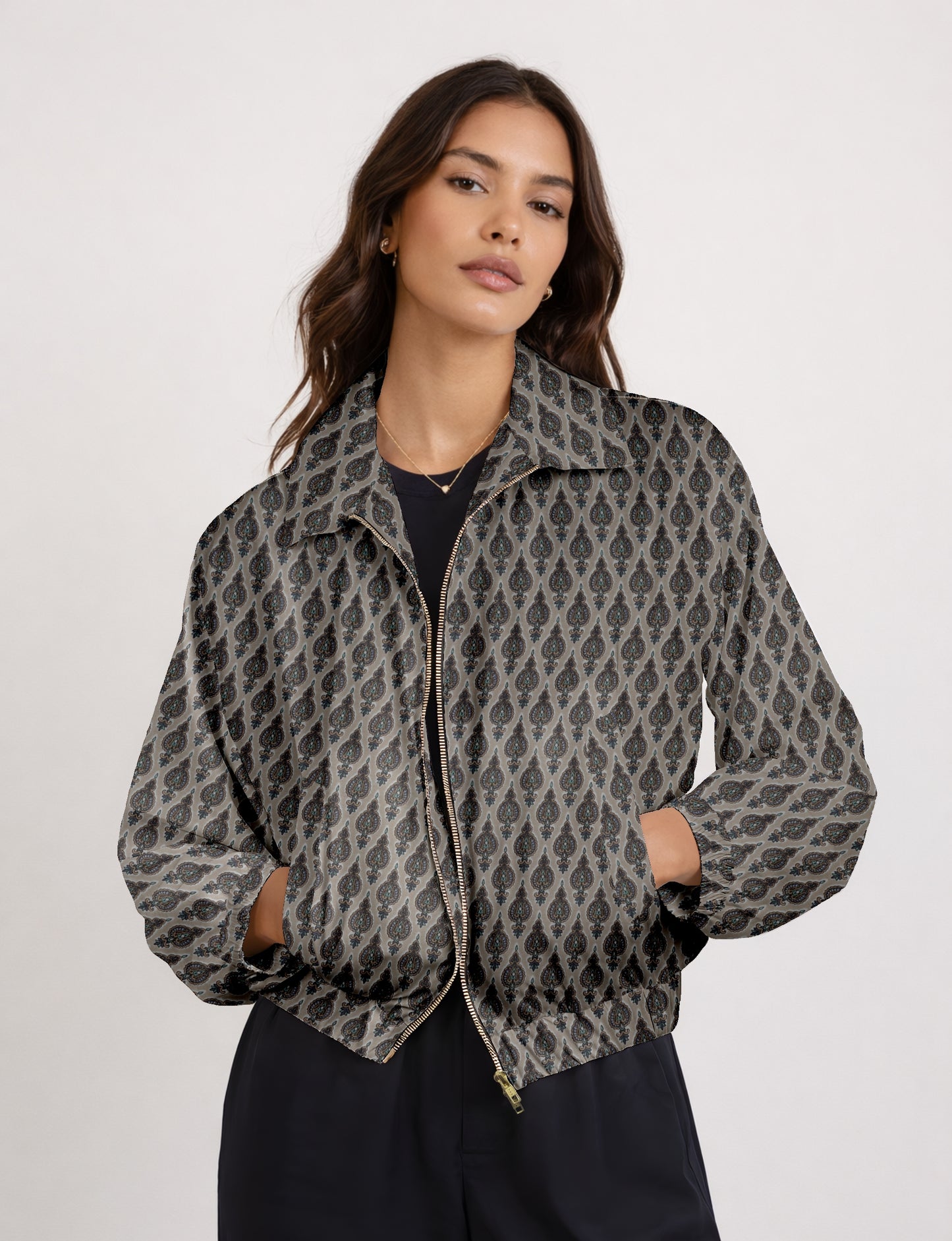 Women's cropped bomber jacket with twin metallic front zippers, welt pockets, elasticated hem and cuffs, and contrast sari print lining.