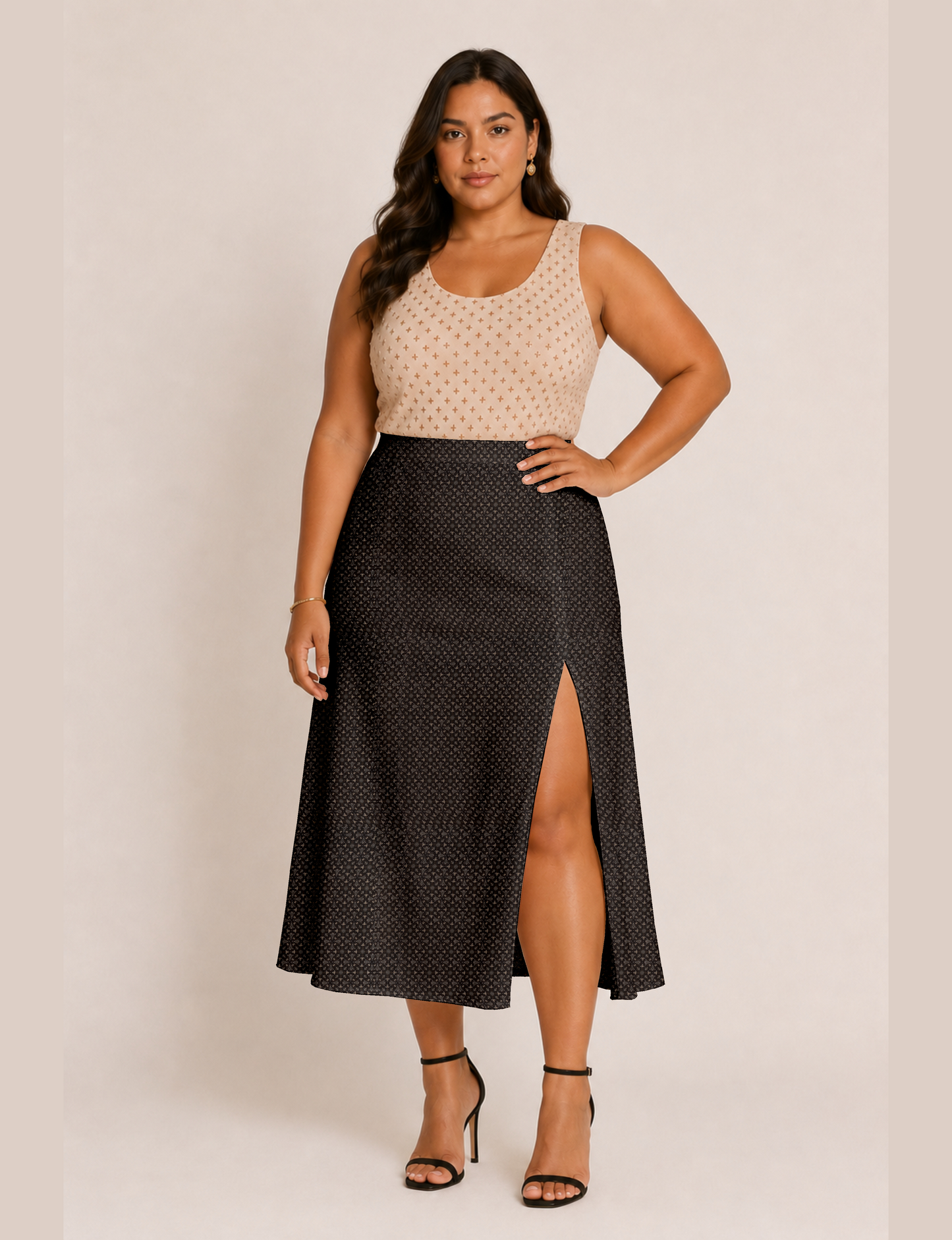 Woman wearing a yellow and black micro patterned A-line skirt with front slit, paired with beige sleeveless top and black