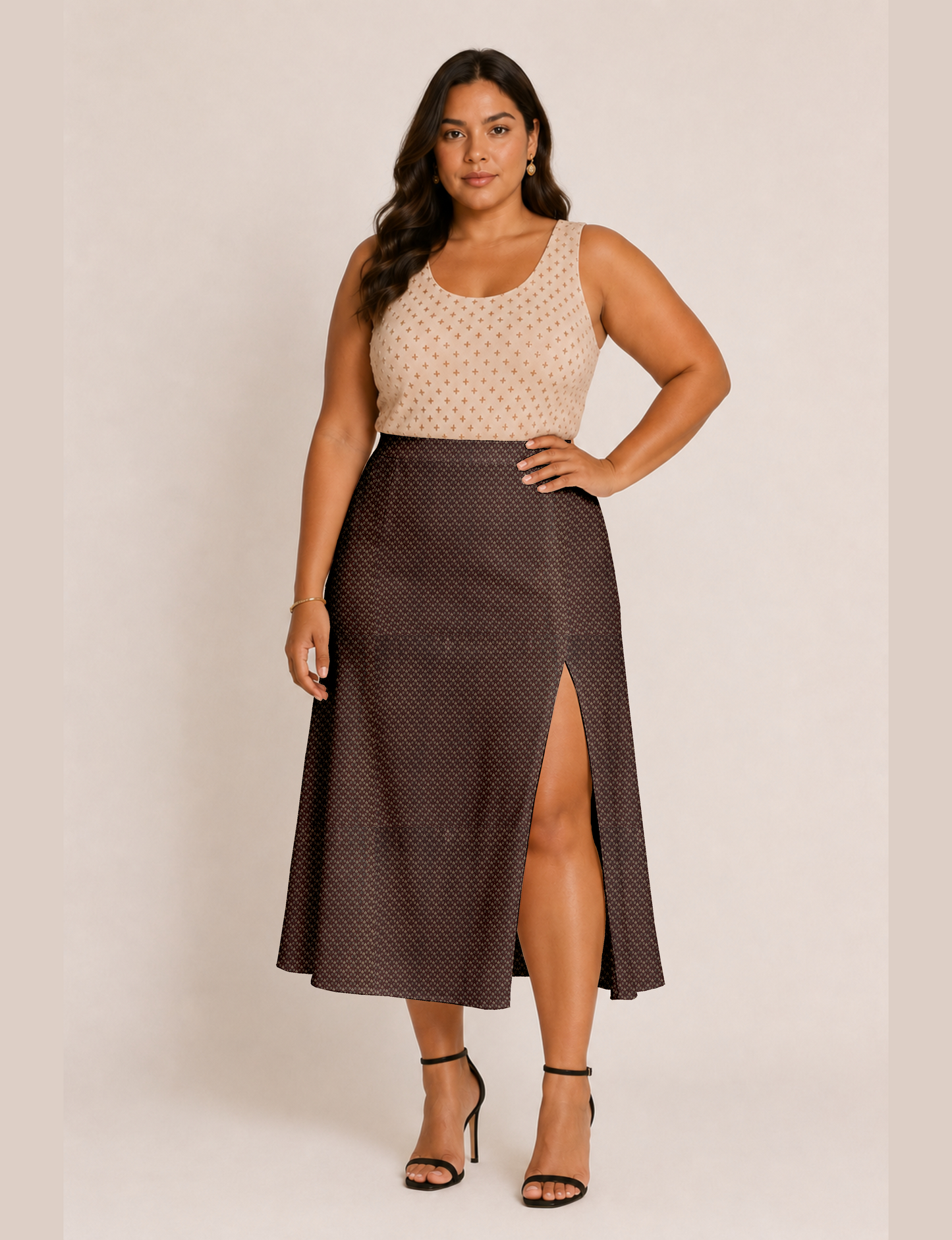 Woman wearing a yellow and black micro patterned A-line skirt with front slit, paired with beige sleeveless top and black