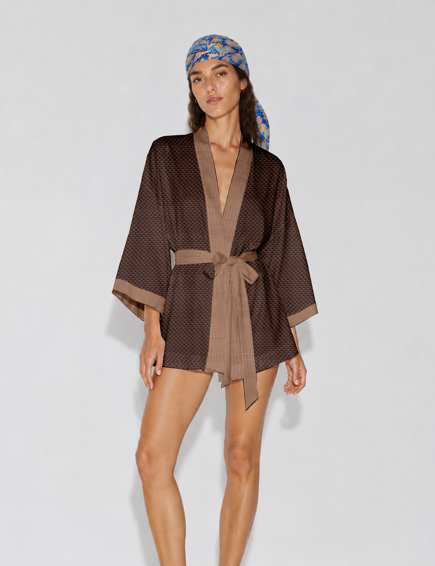 Short kimono robe with wrap front, V-neckline, wide sleeves, waist tie, and concealed skort detail.