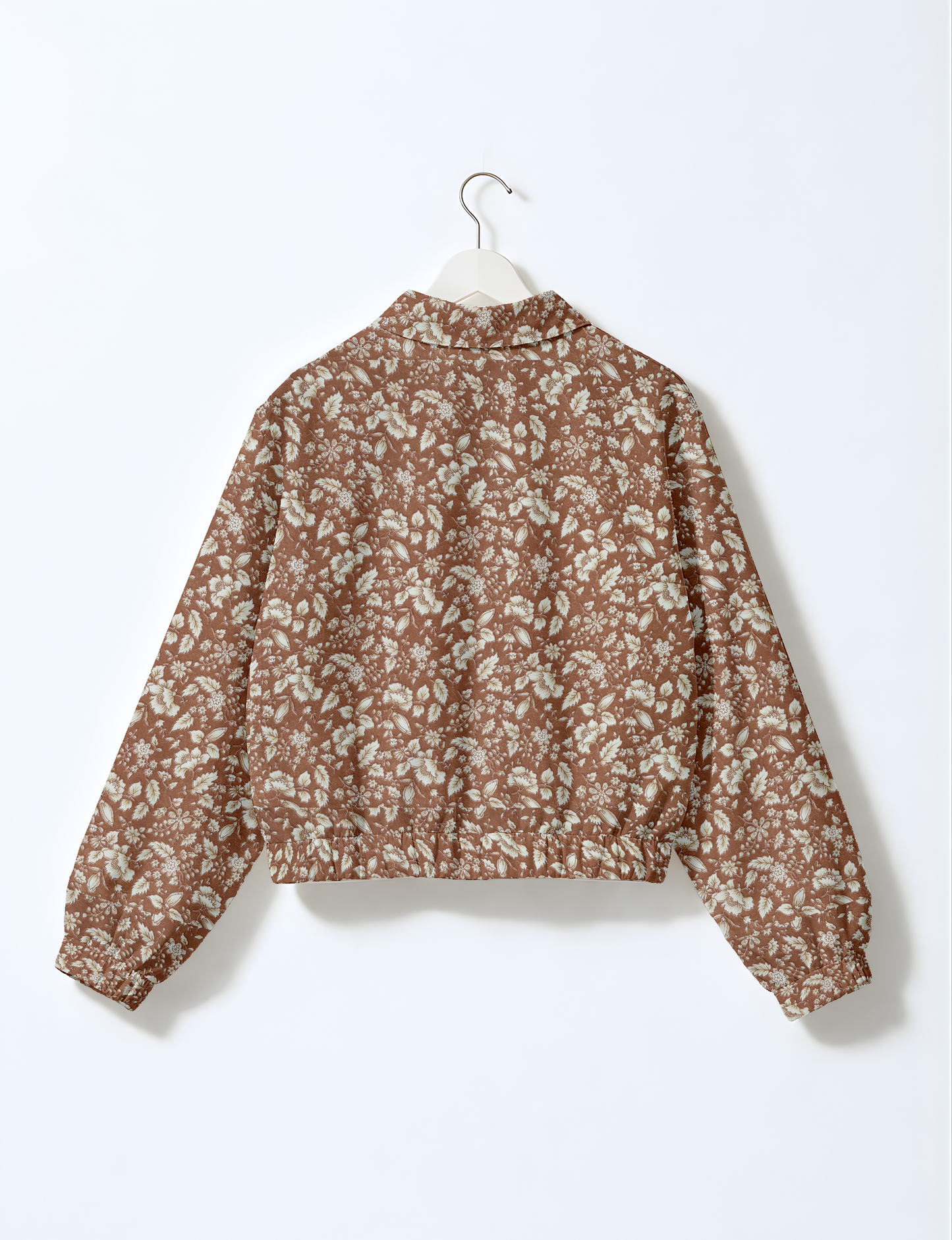 Women's cropped bomber jacket with twin metallic front zippers, welt pockets, elasticated hem and cuffs, and contrast sari print lining.