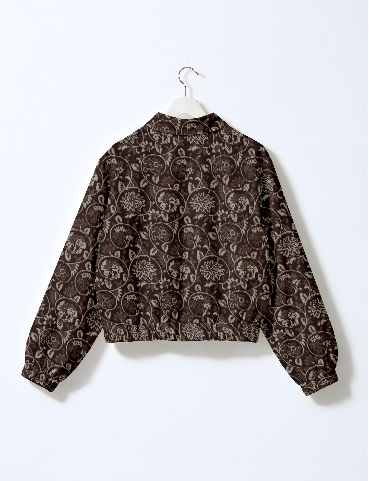 Women's cropped bomber jacket with twin metallic front zippers, welt pockets, elasticated hem and cuffs, and contrast sari print lining.