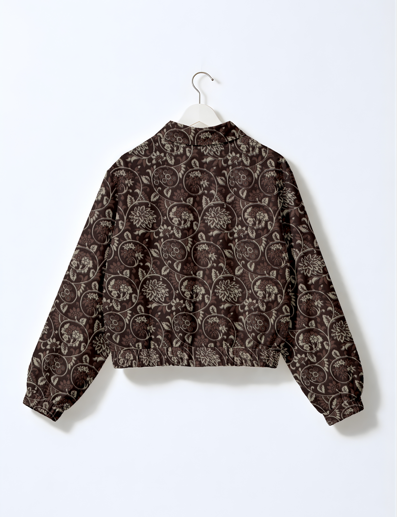 Brown bomber jacket with beige floral swirl pattern, elastic cuffs and waistband, shown from back on white hanger