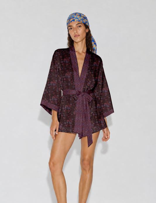 Short kimono robe with wrap front, V-neckline, wide sleeves, waist tie, and concealed skort detail.