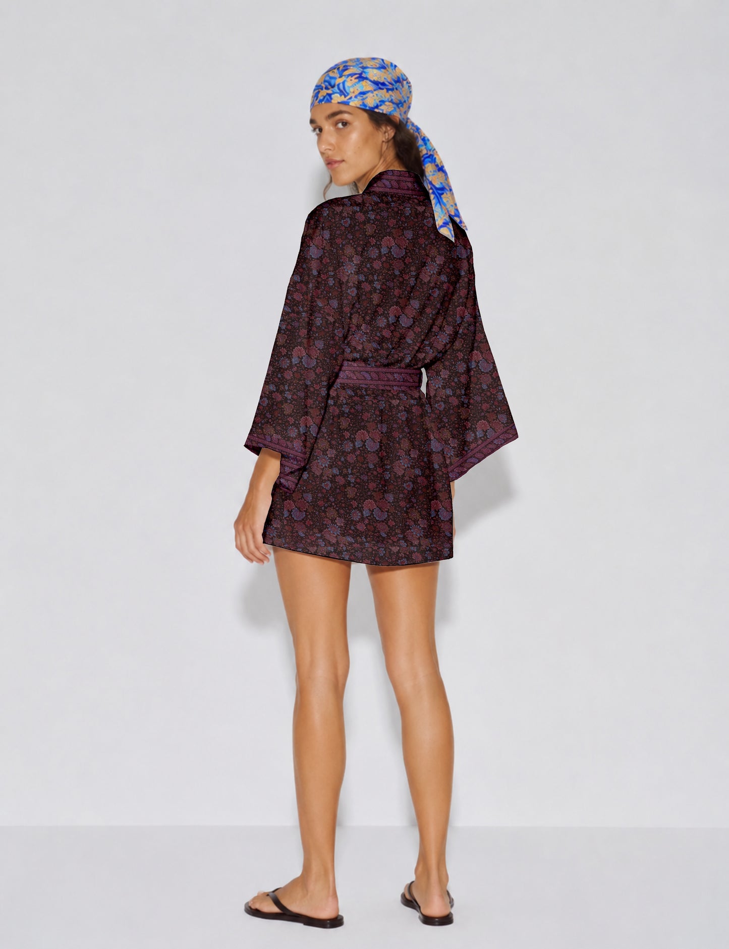 Short kimono robe with wrap front, V-neckline, wide sleeves, waist tie, and concealed skort detail.