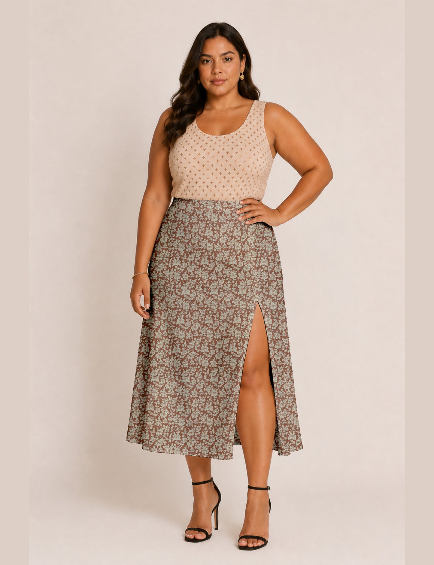 Woman wearing a yellow and black micro patterned A-line skirt with front slit, paired with beige sleeveless top and black