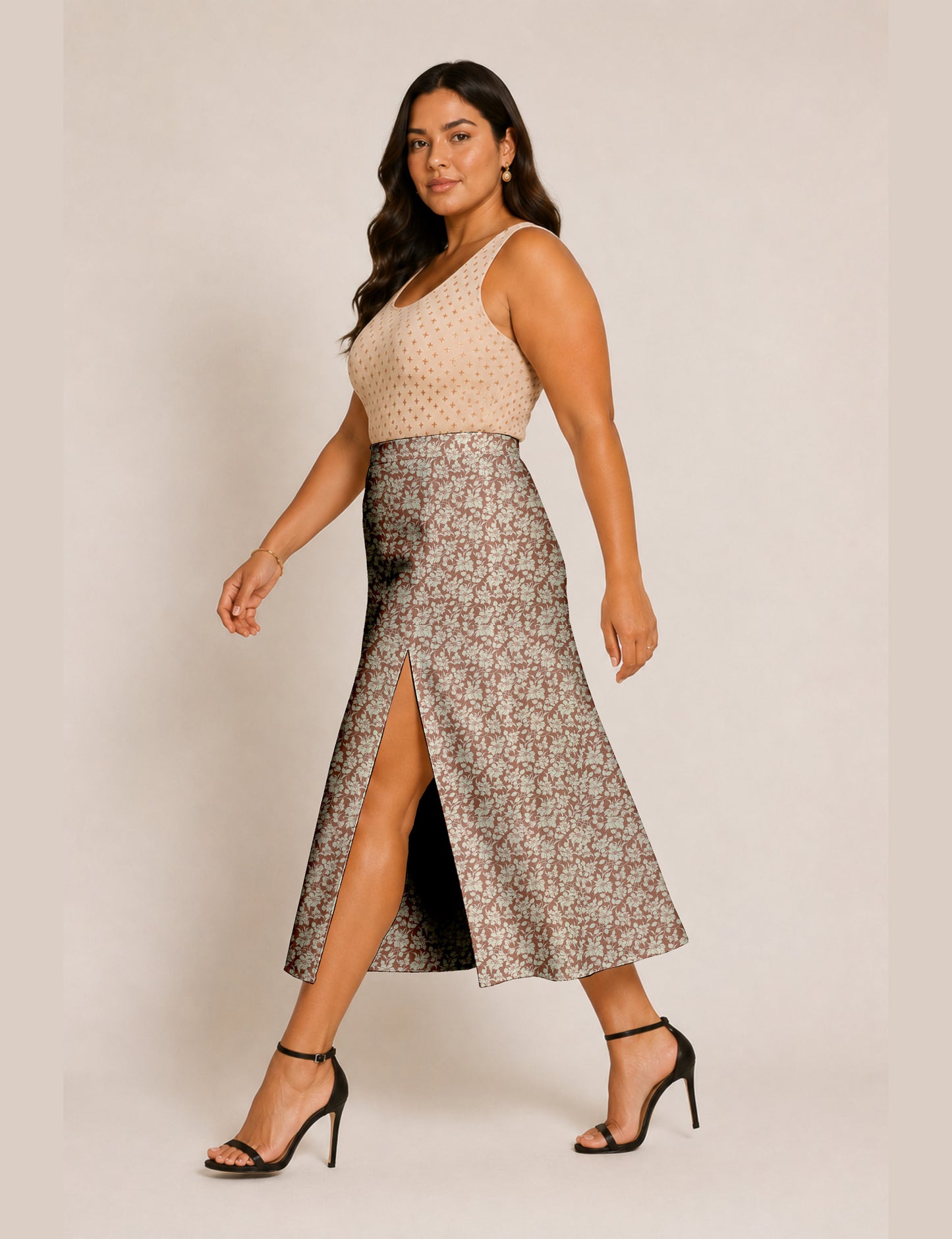 Woman wearing a yellow and black micro patterned A-line skirt with front slit, paired with beige sleeveless top and black