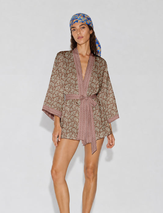 Short kimono robe with wrap front, V-neckline, wide sleeves, waist tie, and concealed skort detail.