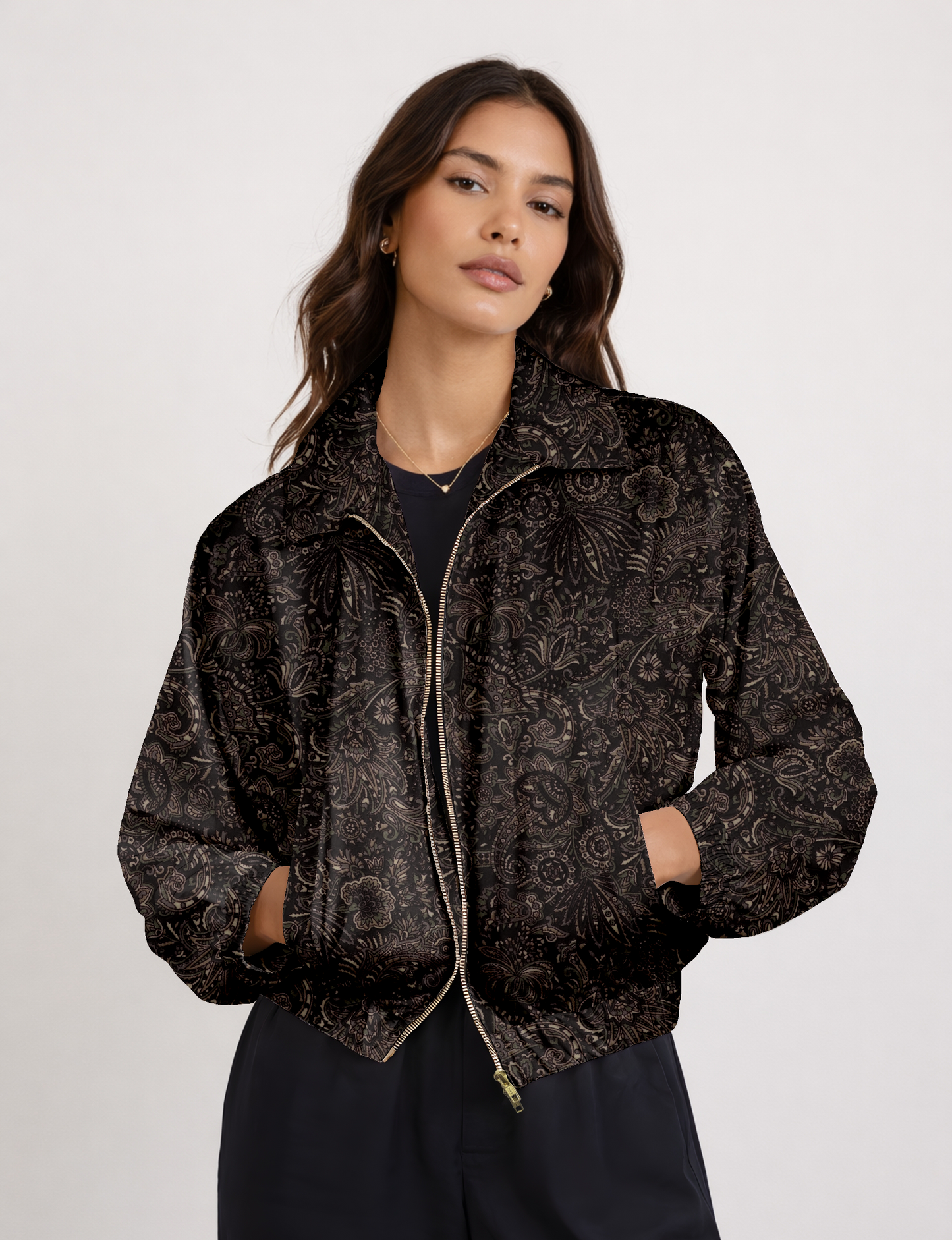 Women's cropped bomber jacket with twin metallic front zippers, welt pockets, elasticated hem and cuffs, and contrast sari print lining.