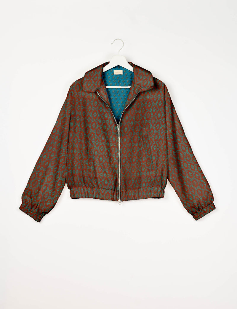 Brown bomber jacket with teal Indian ethnic pattern, front zipper, elastic cuffs and waistband, shown on white hanger front