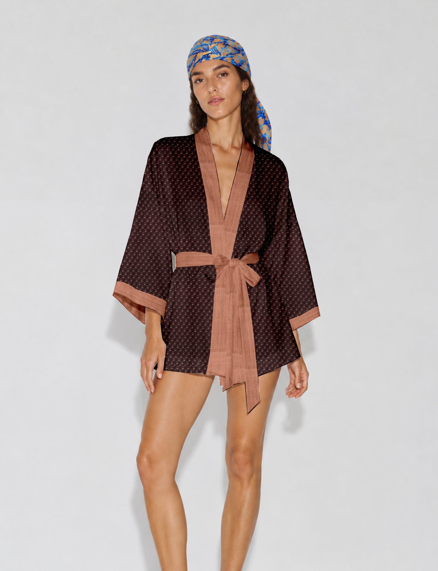Short kimono robe with wrap front, V-neckline, wide sleeves, waist tie, and concealed skort detail.
