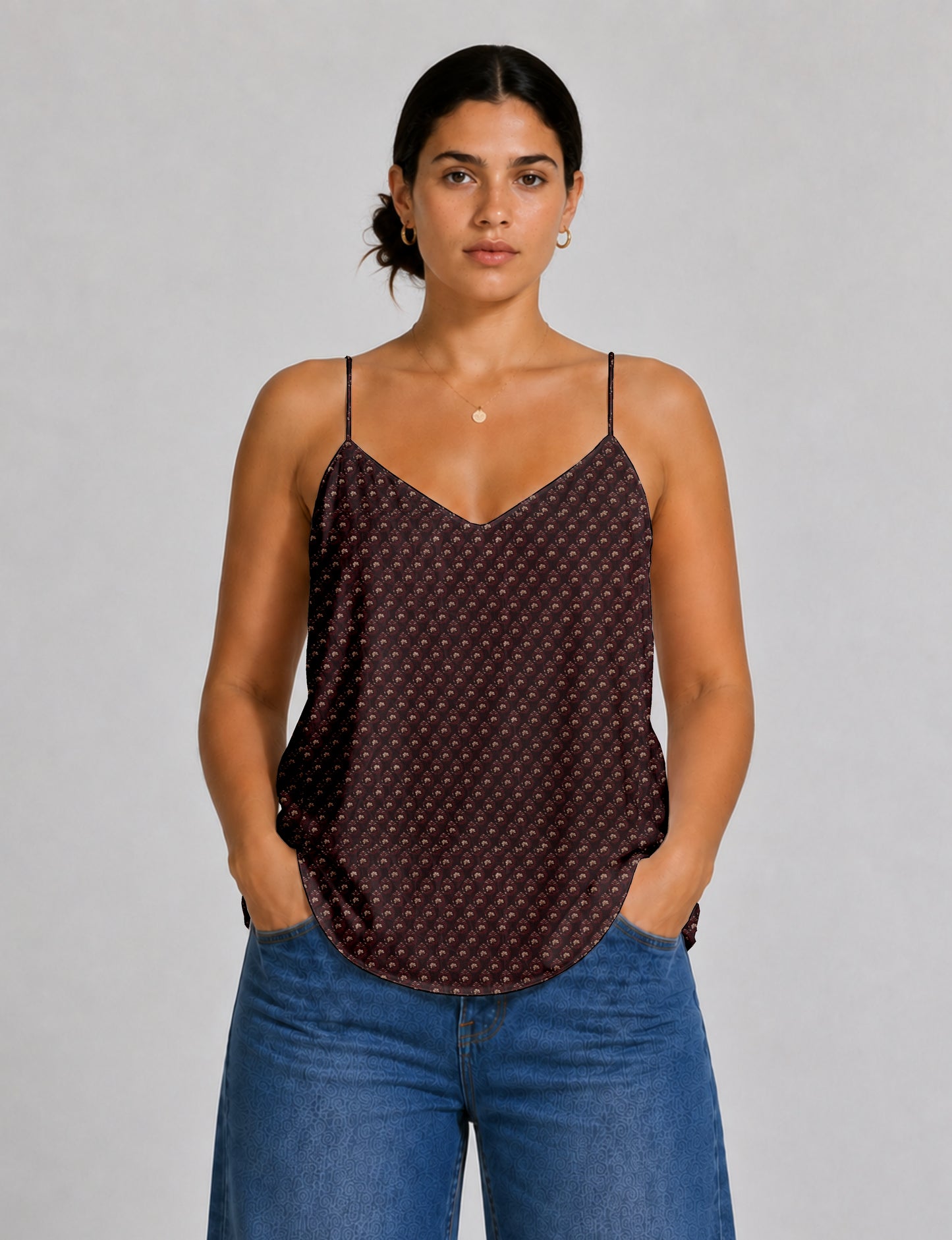 Women's sleeveless slip top with a relaxed straight fit, soft V-neckline, deep V-back, and delicate spaghetti straps.
