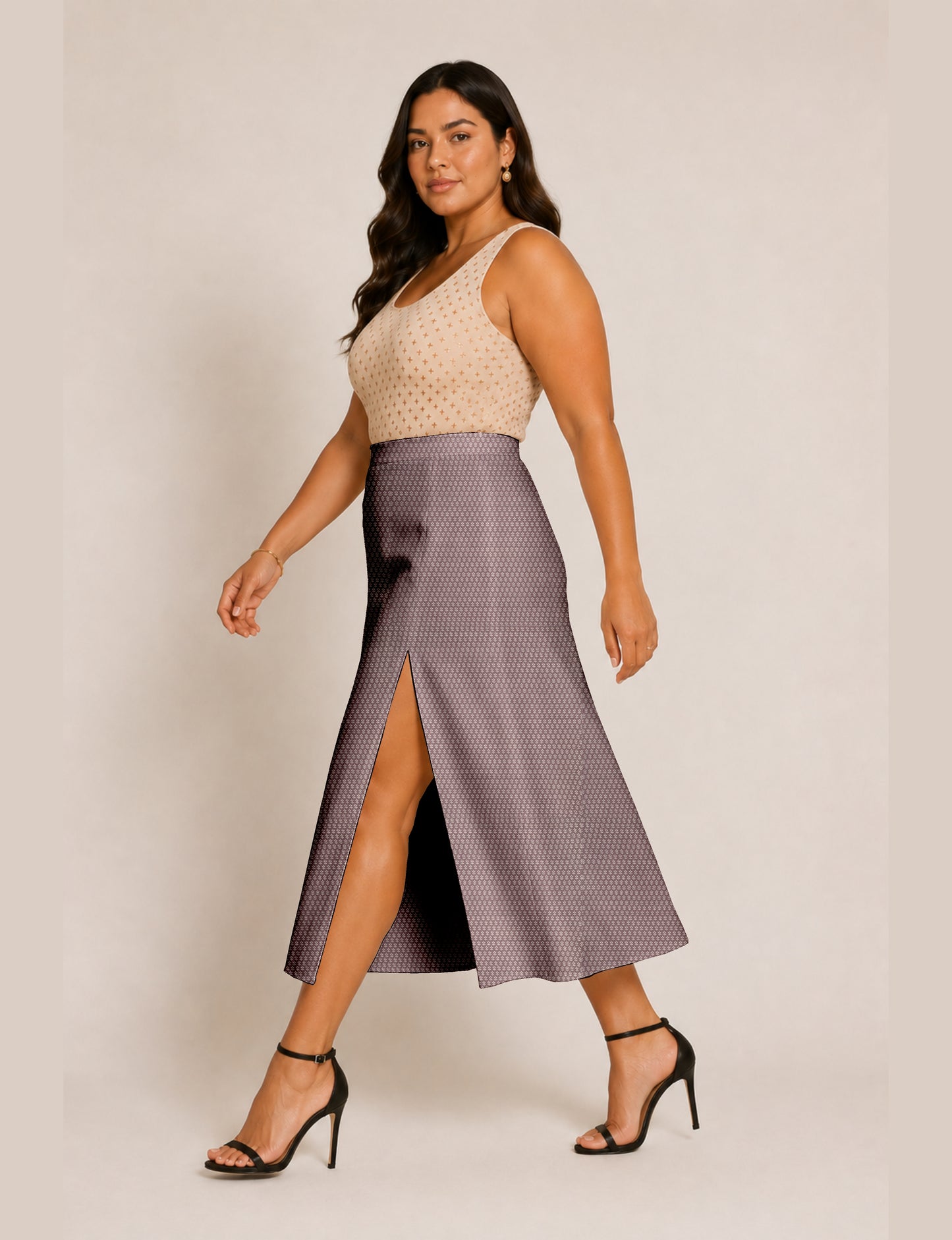 Woman wearing a yellow and navy blue A-line skirt with a slit and a sleeveless beige top with brown micro print