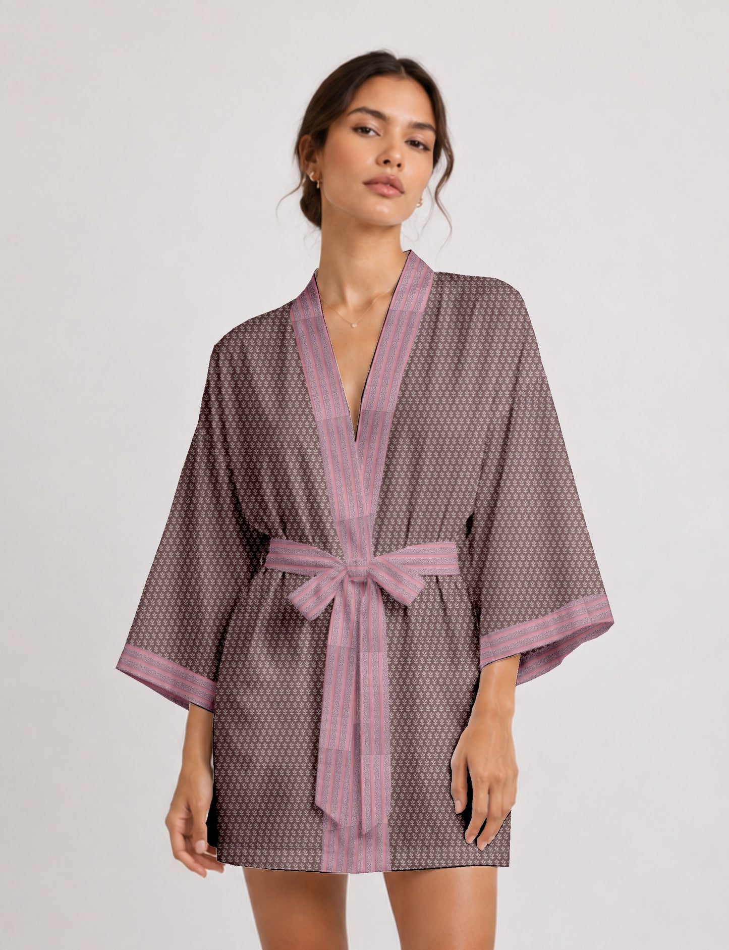 Short kimono robe with wrap front, V-neckline, wide sleeves, waist tie, and concealed skort detail.