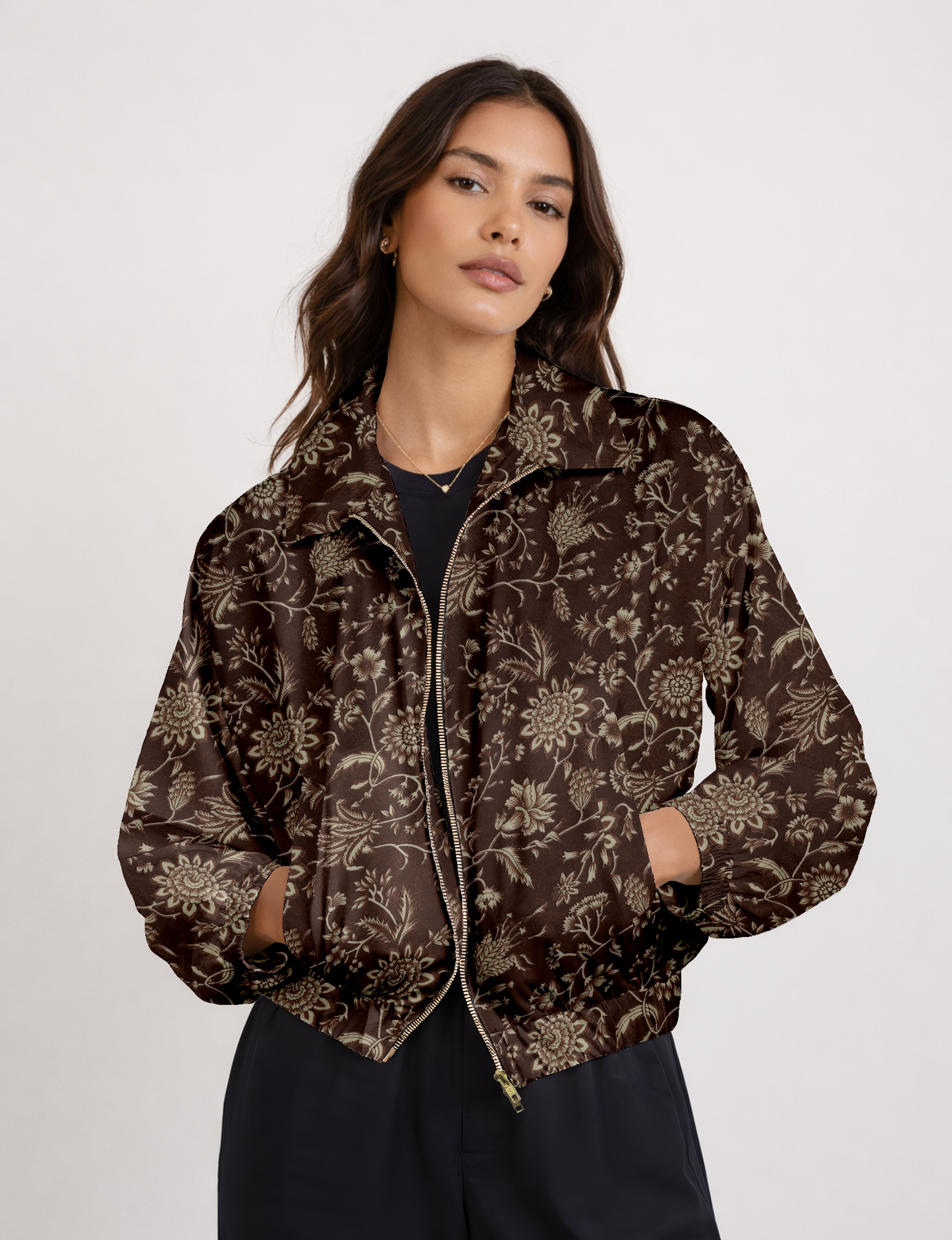 Women's cropped bomber jacket with twin metallic front zippers, welt pockets, elasticated hem and cuffs, and contrast sari print lining.