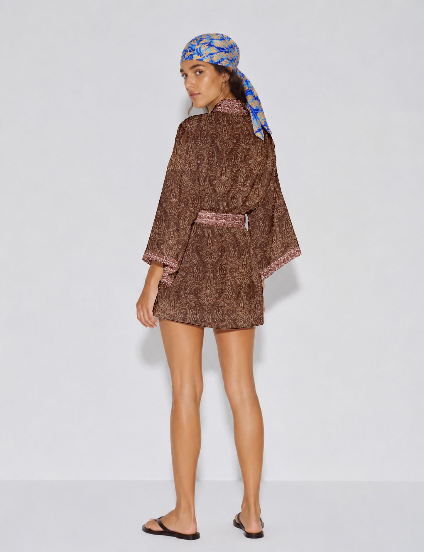 Short kimono robe with wrap front, V-neckline, wide sleeves, waist tie, and concealed skort detail.