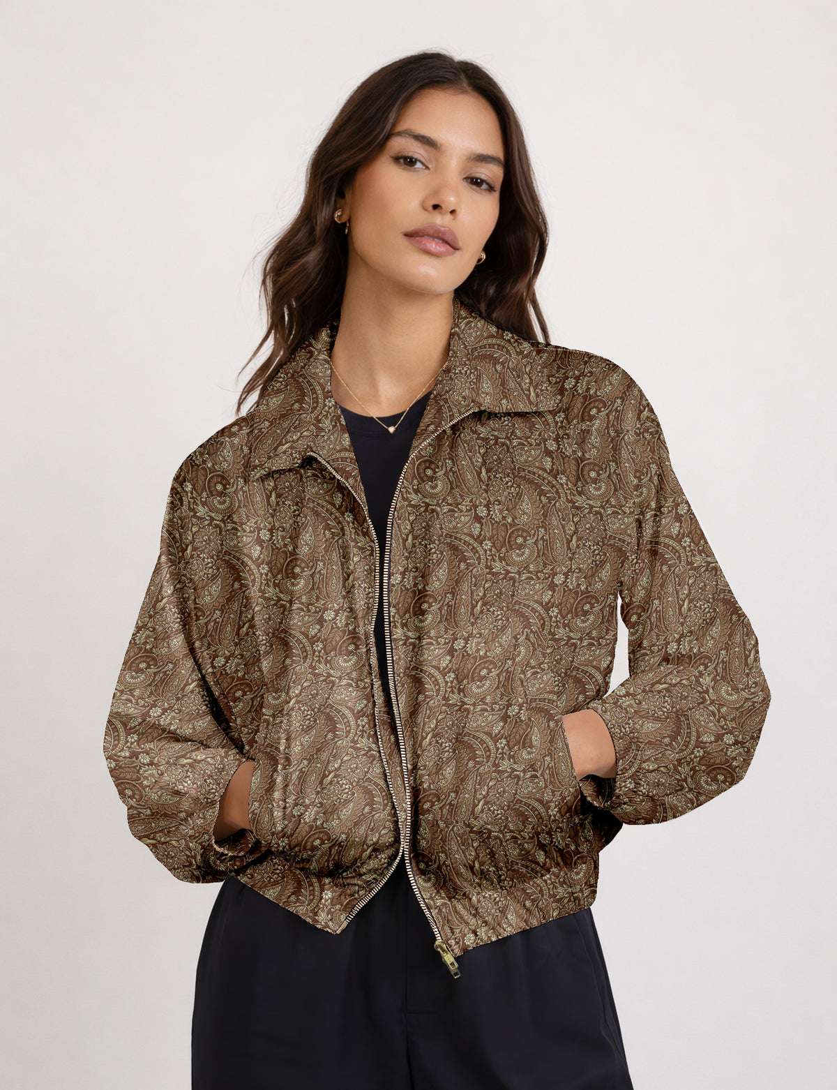 Woman wearing a yellow floral bomber jacket with front zipper, elastic cuffs, and side pockets, shown from front view
