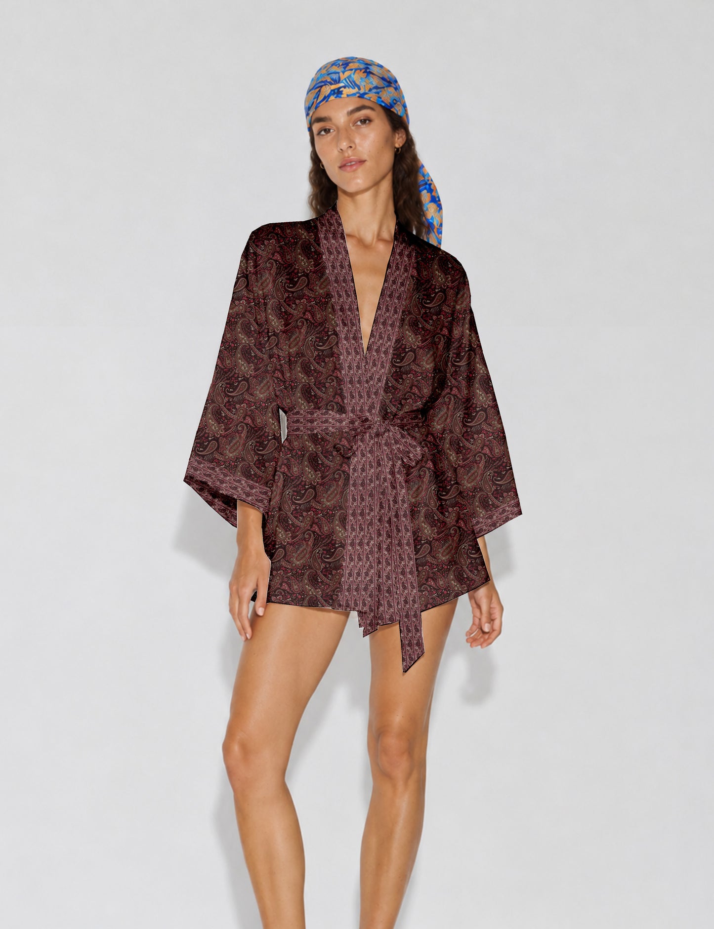 Short kimono robe with wrap front, V-neckline, wide sleeves, waist tie, and concealed skort detail.