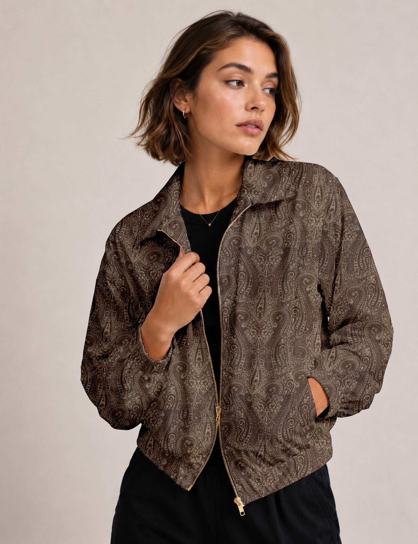 Brown floral bomber jacket with front zipper, elastic cuffs and hem, hanging on white hanger, red floral inner lining visible
