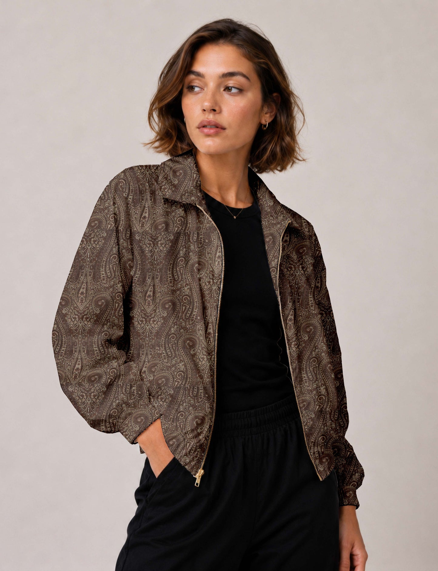 Woman wearing a yellow floral bomber jacket with front zipper, elastic cuffs, and side pockets, shown from front view