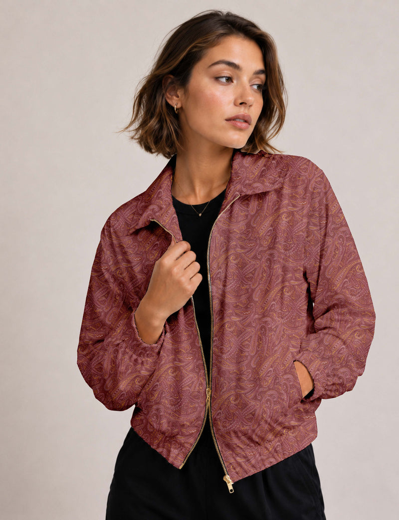 Woman wearing a yellow floral bomber jacket with front zipper, elastic cuffs, and side pockets, shown from front view