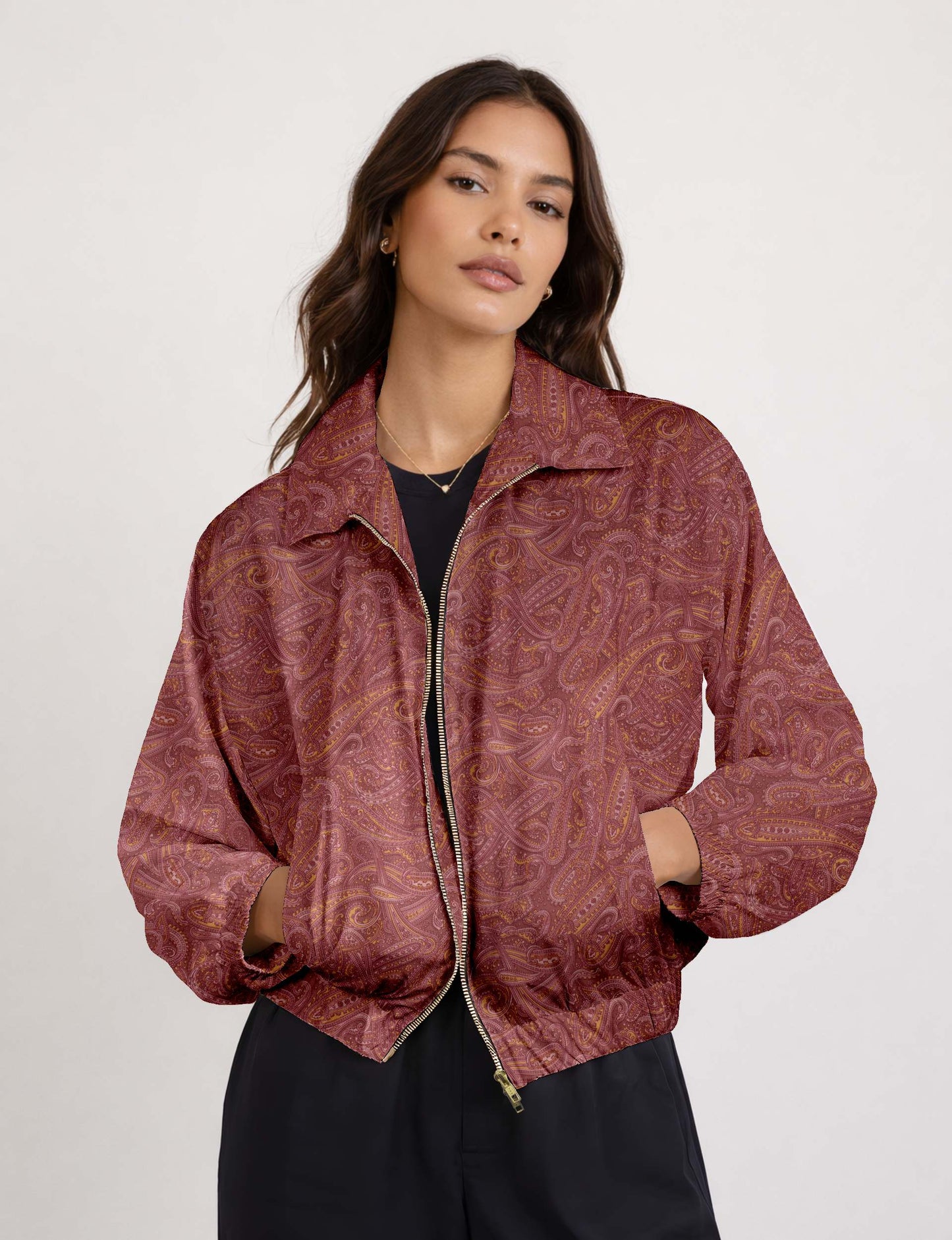 Woman wearing a yellow floral bomber jacket with front zipper, elastic cuffs, and side pockets, shown from front view