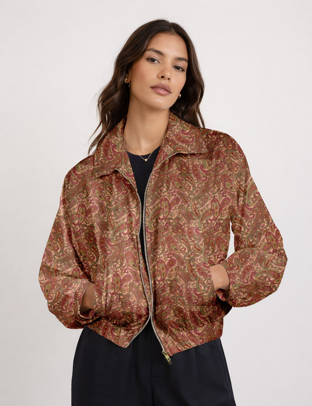 Brown floral bomber jacket with front zipper, elastic cuffs and hem, hanging on white hanger, red floral inner lining visible