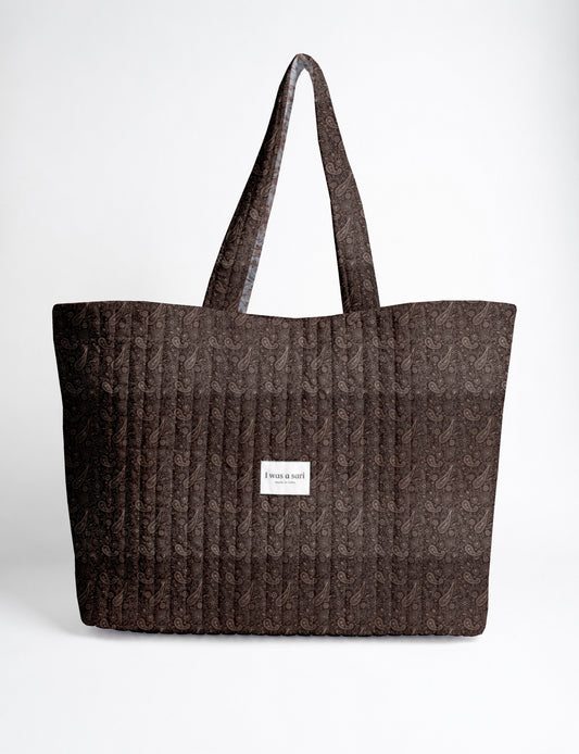 Large quilted beach bag with spacious rectangular design, reinforced shoulder straps, and open-top construction for everyday use and travel.