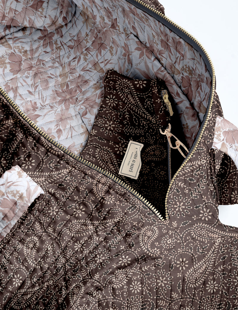 Quilted brown paisley bowling bag with gold zipper, floral interior lining, and interior key clip with label inside pocket