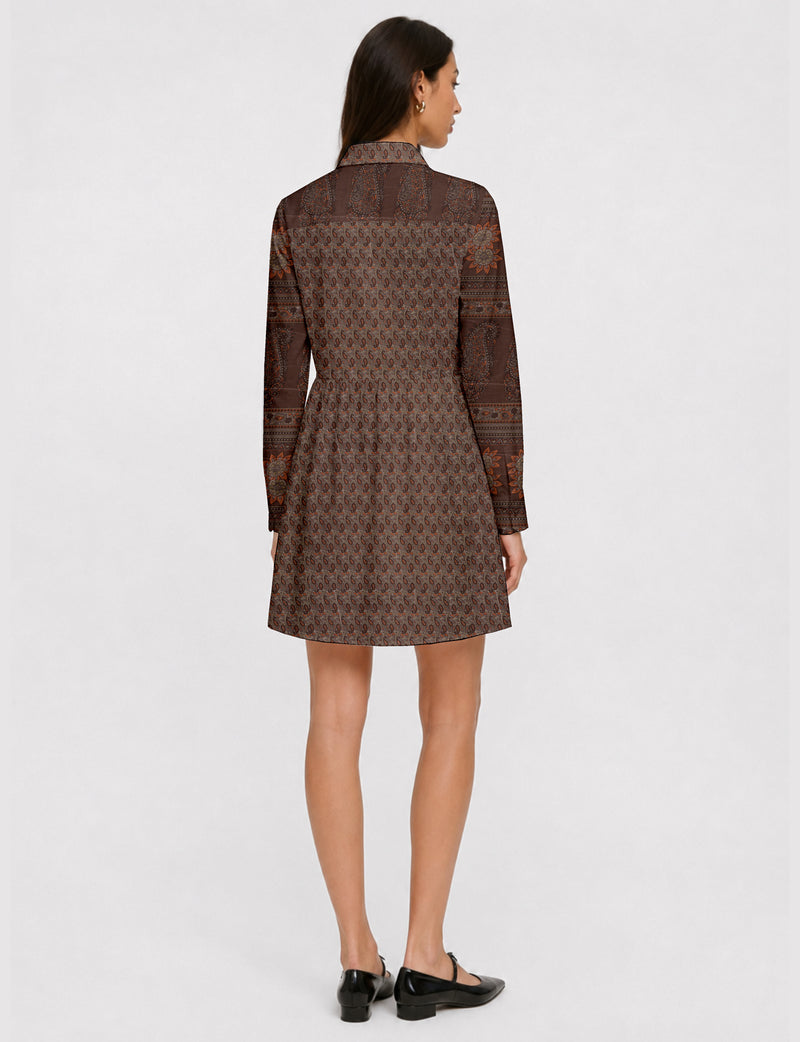 Short shirt dress with a relaxed A-line silhouette, point collar, partial button placket, gathered waist, side pockets, and full-length cuffed sleeves.