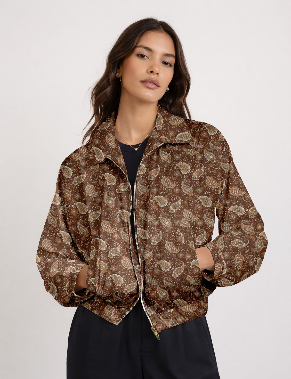 Woman wearing a yellow floral bomber jacket with front zipper, elastic cuffs, and side pockets, shown from front view