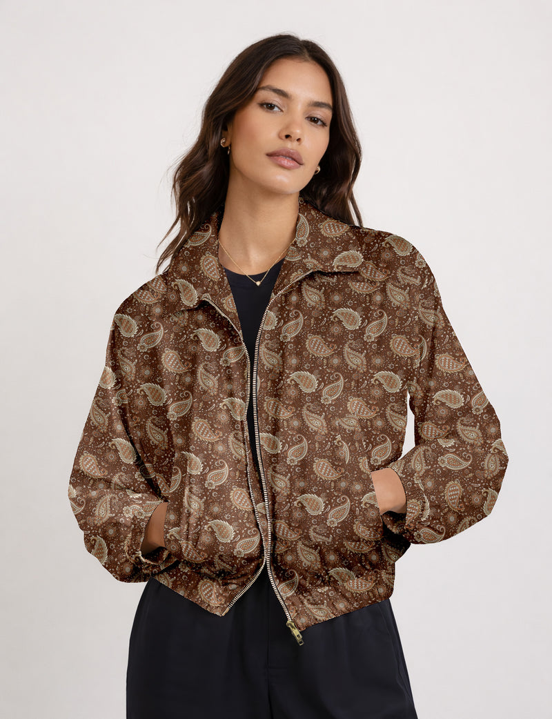 Woman wearing a yellow floral bomber jacket with front zipper, elastic cuffs, and side pockets, shown from front view