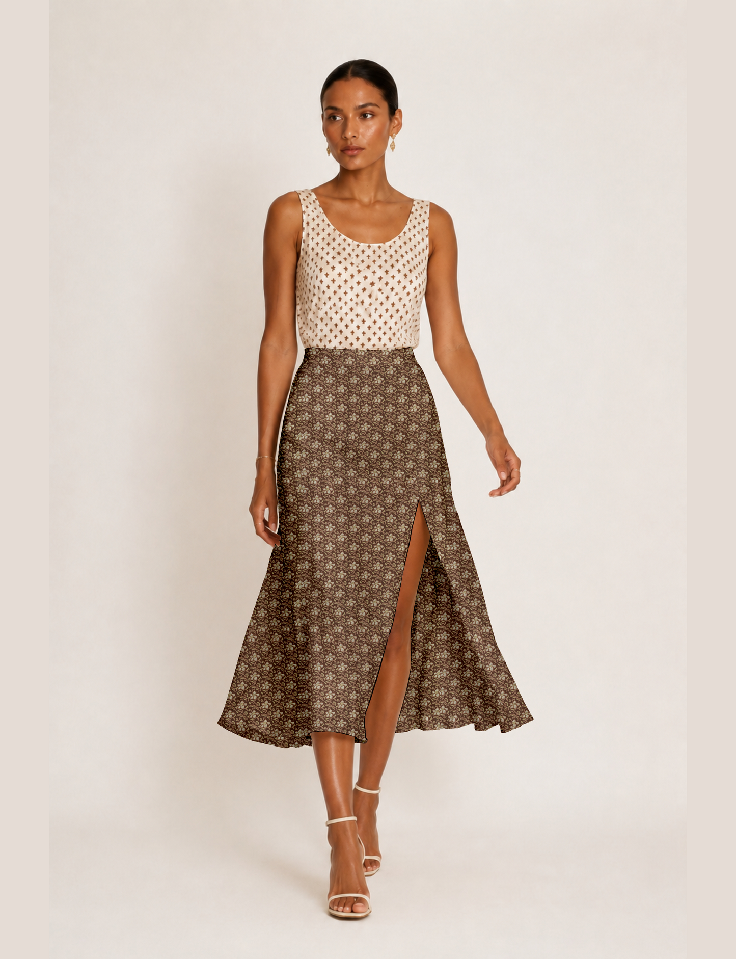Woman wearing a yellow and black micro patterned A-line skirt with front slit, paired with beige sleeveless top and black