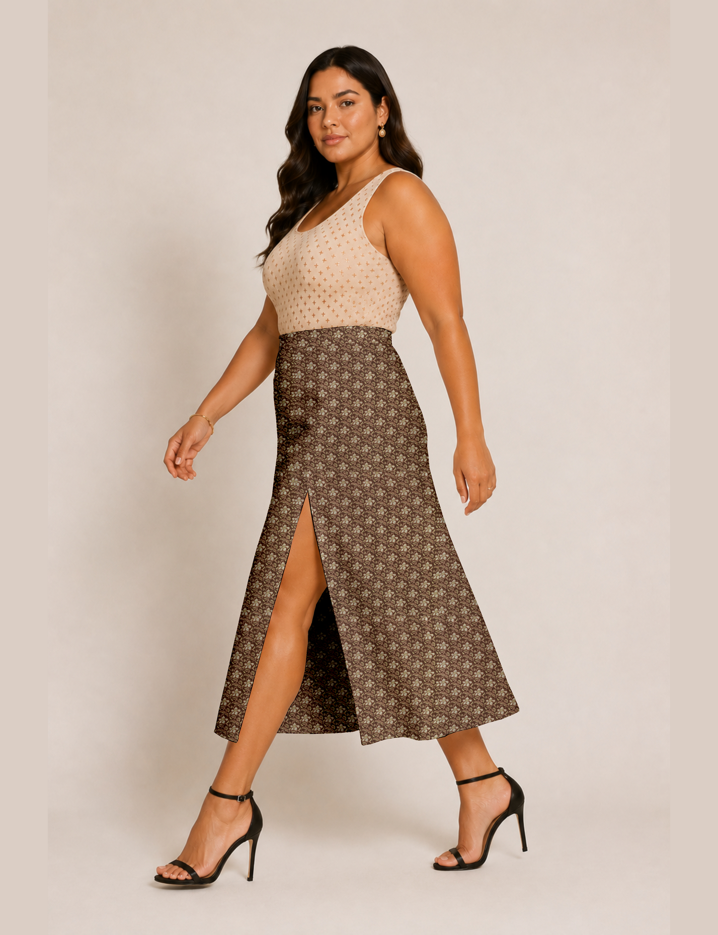 Woman wearing a yellow and black micro patterned A-line skirt with front slit, paired with beige sleeveless top and black