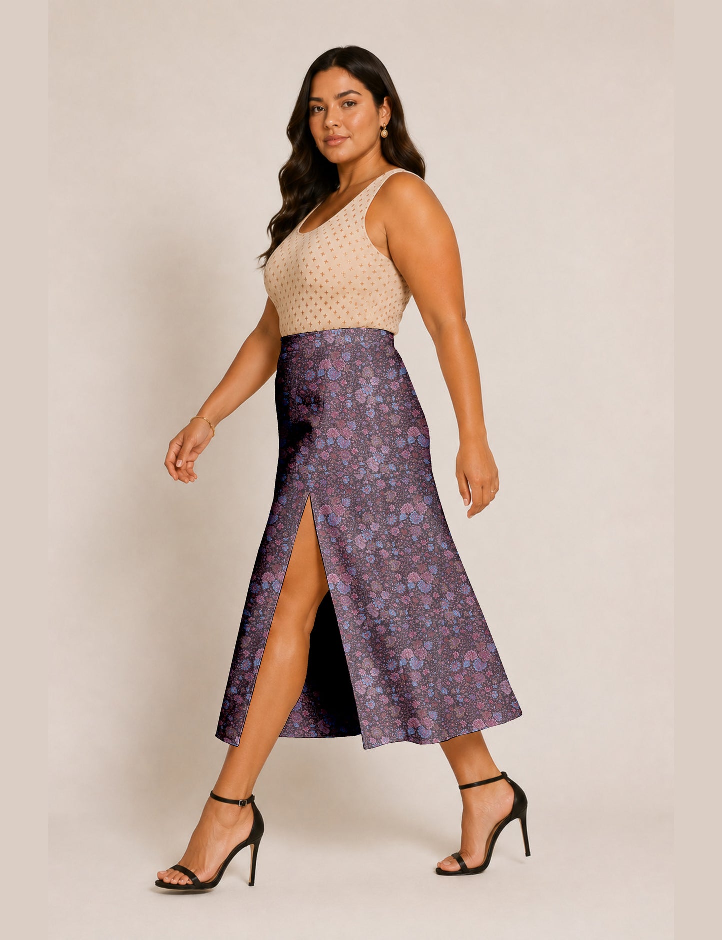 Woman wearing a yellow and black micro patterned A-line skirt with front slit, paired with beige sleeveless top and black