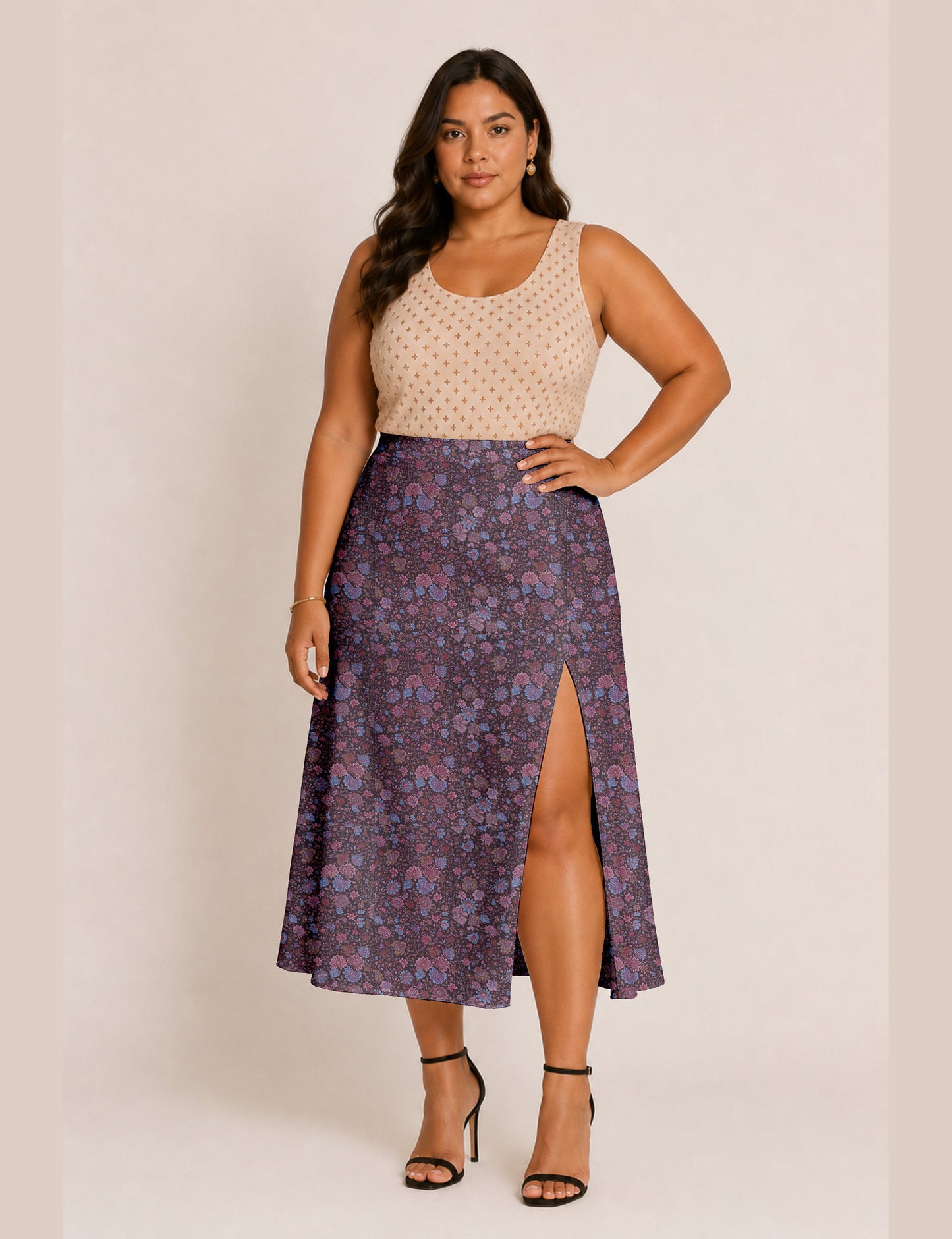 Woman wearing a yellow and black micro patterned A-line skirt with front slit, paired with beige sleeveless top and black