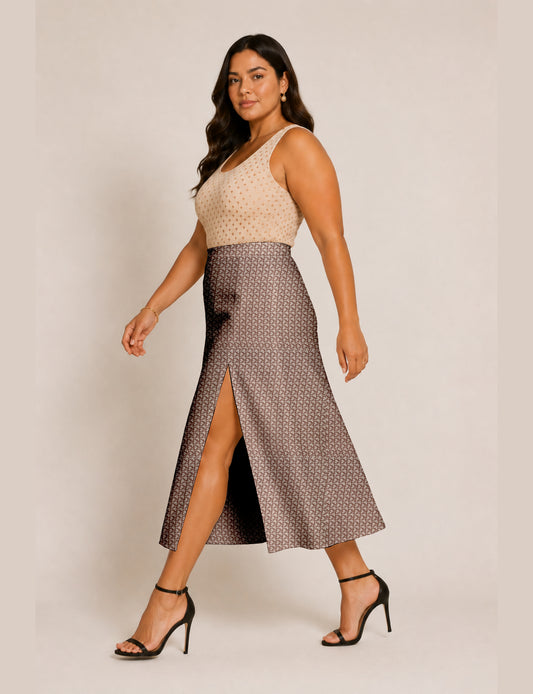 Woman wearing a yellow and black micro patterned A-line skirt with front slit, paired with beige sleeveless top and black
