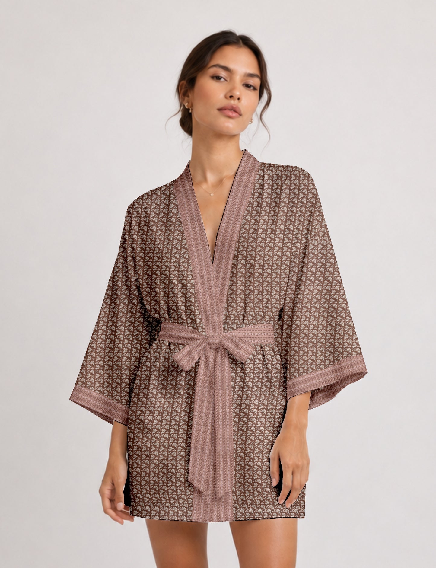 Short kimono robe with wrap front, V-neckline, wide sleeves, waist tie, and concealed skort detail.