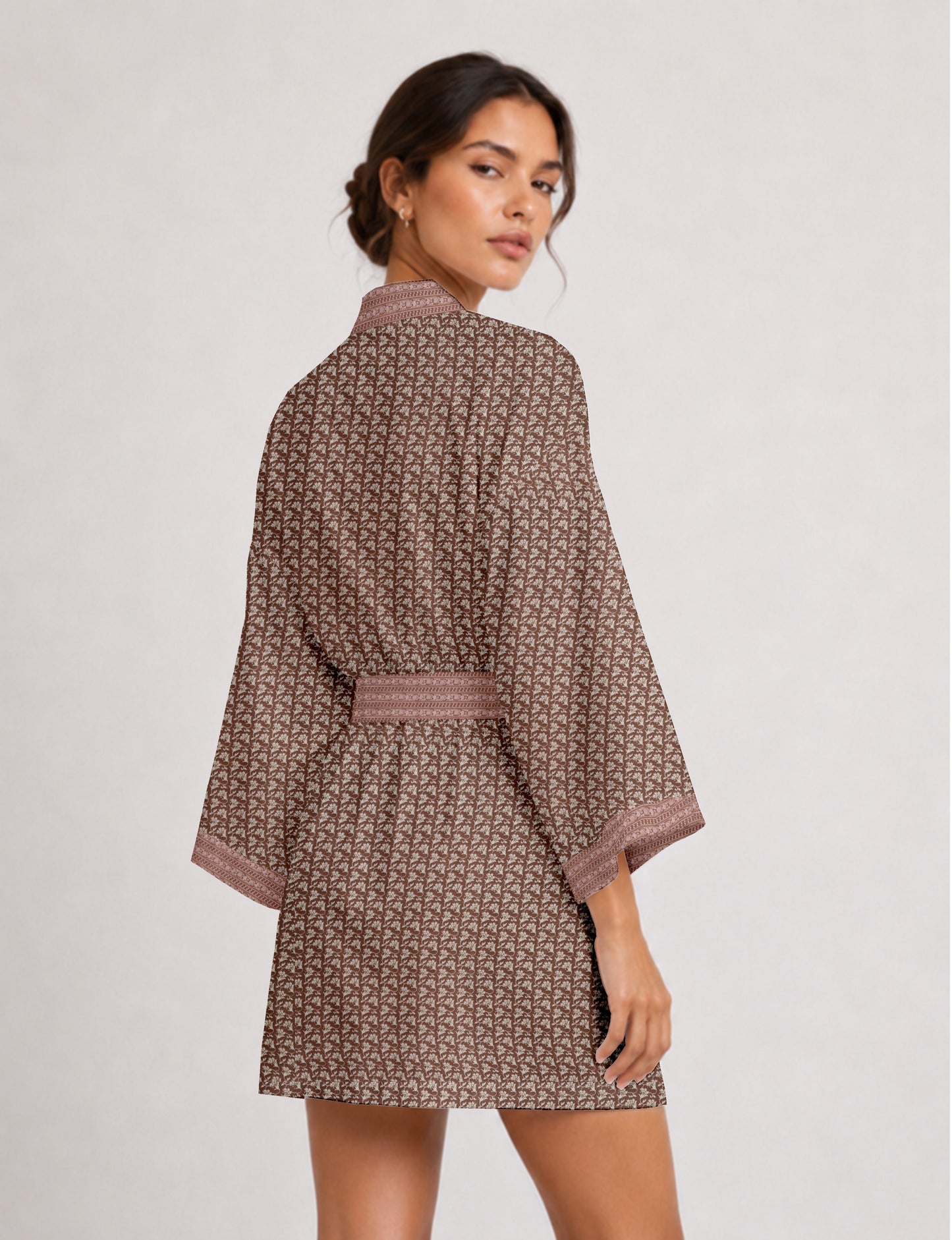 Short kimono robe with wrap front, V-neckline, wide sleeves, waist tie, and concealed skort detail.