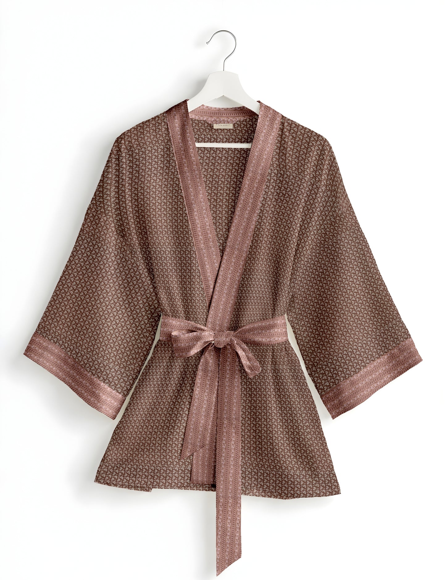Short kimono robe with wrap front, V-neckline, wide sleeves, waist tie, and concealed skort detail.