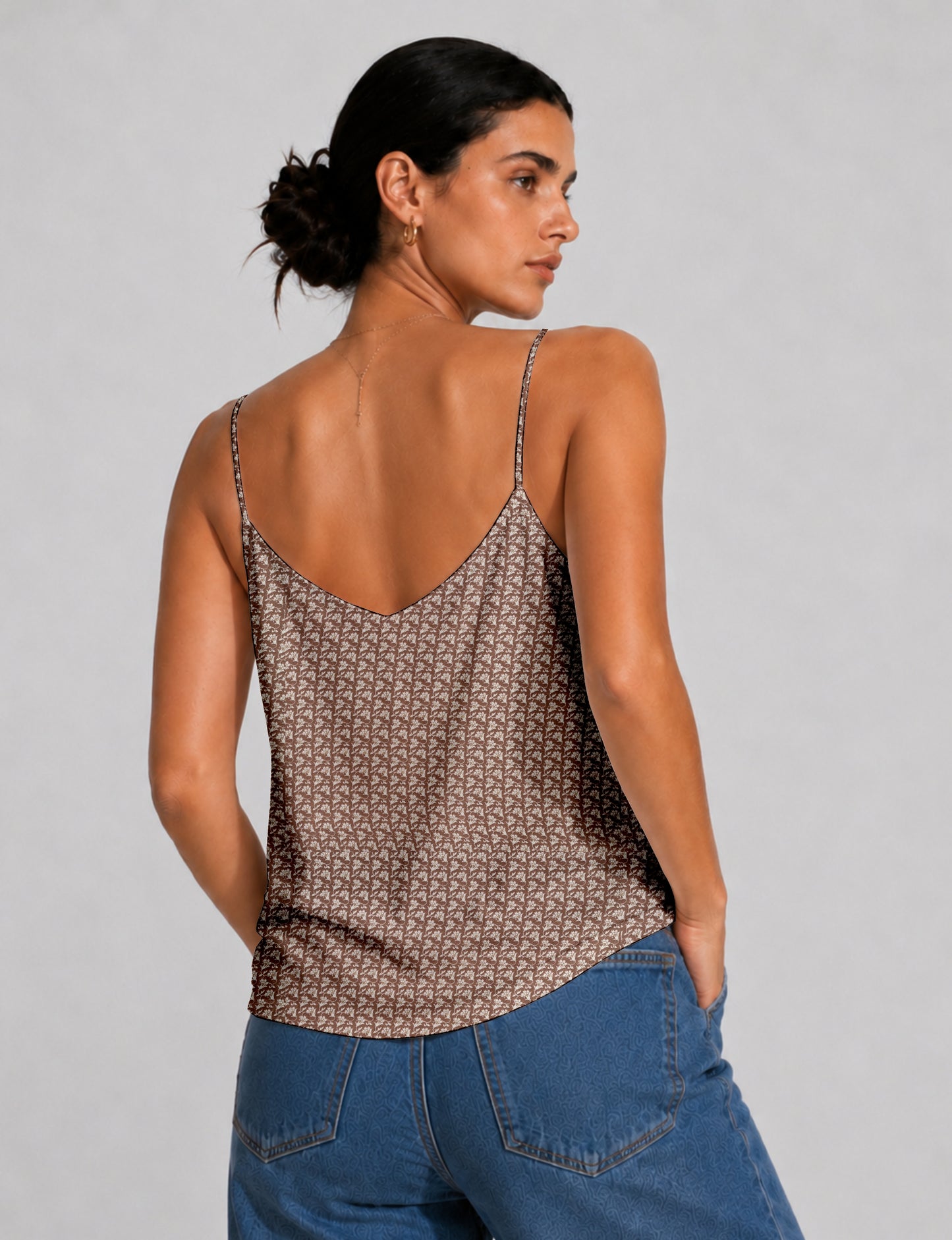 Women's sleeveless slip top with a relaxed straight fit, soft V-neckline, deep V-back, and delicate spaghetti straps.