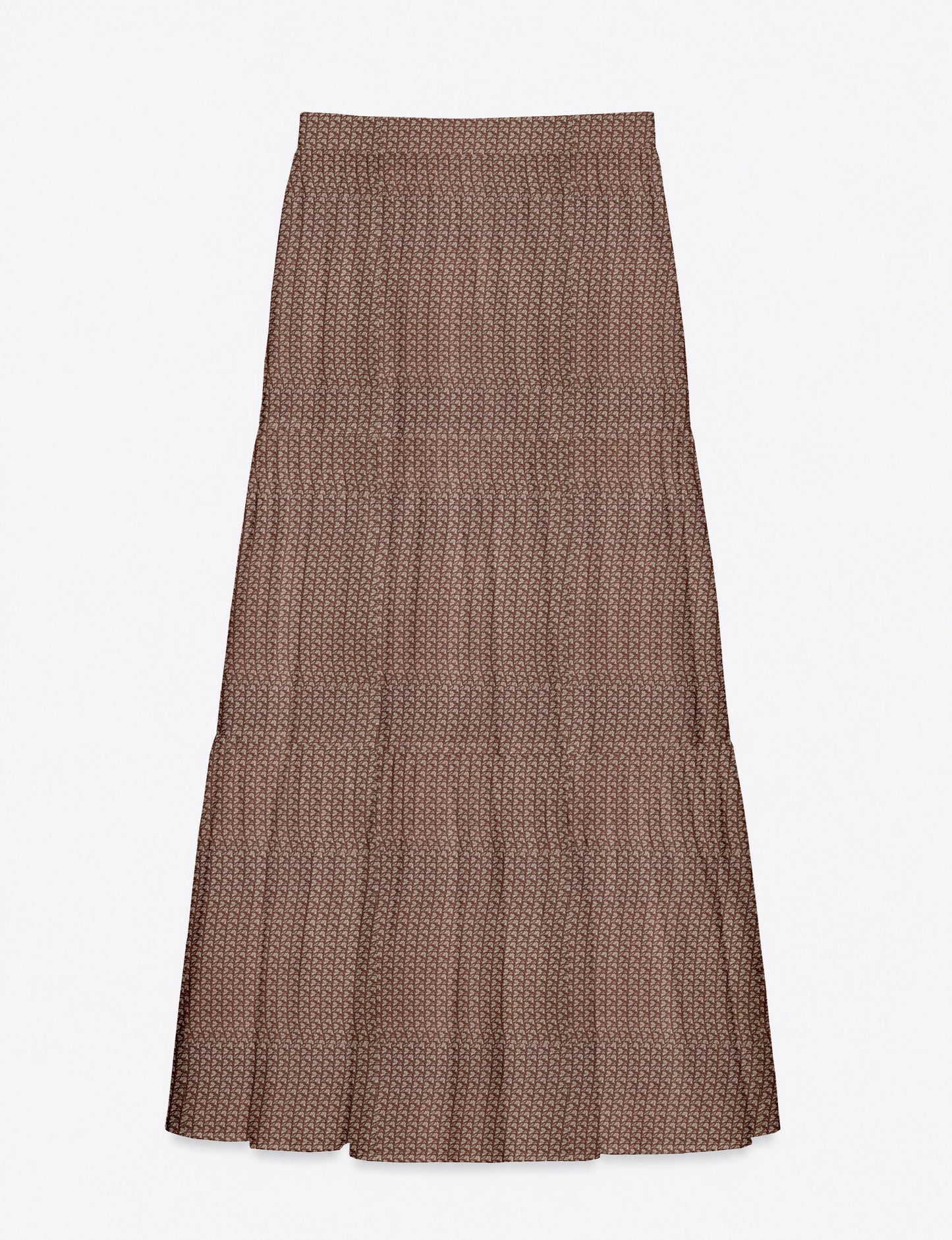 Woman wearing a yellow midi tiered skirt with a small geometric pattern, paired with a beige strapless top and white heels